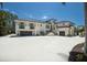Grand home featuring a spacious driveway, multiple garages, and beautiful architecture against a bright blue sky at 705 89Th Nw Ct, Bradenton, FL 34209