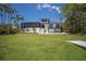 Exterior view of the house with a boat lift, lush lawn, and a screened-in pool at 705 89Th Nw Ct, Bradenton, FL 34209