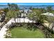 Elegant residence with a well-manicured lawn, mature trees, and a circular driveway providing ample parking space at 705 89Th Nw Ct, Bradenton, FL 34209