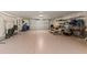 Spacious garage featuring speckled epoxy floors, ample storage and a white garage door at 705 89Th Nw Ct, Bradenton, FL 34209