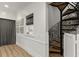 Hallway with hardwood floors and artistic spiral staircase with beautiful iron and wood design at 705 89Th Nw Ct, Bradenton, FL 34209