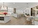 Open kitchen design with white cabinets, luxury countertops, an island, and seating at 705 89Th Nw Ct, Bradenton, FL 34209