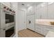 Modern kitchen features a stainless steel Wolf oven, custom cabinets, marble countertops, and stainless-steel appliances at 705 89Th Nw Ct, Bradenton, FL 34209