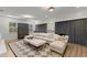 Spacious living room with a plush sectional sofa, stylish rug, and modern decor at 705 89Th Nw Ct, Bradenton, FL 34209