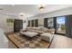 Relaxing living area featuring a large sectional sofa, patterned rug, and floor to ceiling windows with lake view at 705 89Th Nw Ct, Bradenton, FL 34209