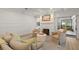 Bright living room featuring comfortable seating, a fireplace, and beautiful decor with views to the outside balcony at 705 89Th Nw Ct, Bradenton, FL 34209
