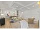 Spacious living room with an open layout to the kitchen, comfortable seating, and coffered ceilings at 705 89Th Nw Ct, Bradenton, FL 34209