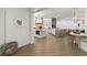 Bright, open-concept living space showcasing luxury vinyl flooring, kitchen, and breakfast nook at 705 89Th Nw Ct, Bradenton, FL 34209