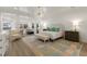 A serene main bedroom boasts ample space, natural light, and stylish furnishings at 705 89Th Nw Ct, Bradenton, FL 34209