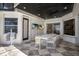 Covered outdoor patio with an outdoor dining table and television at 705 89Th Nw Ct, Bradenton, FL 34209