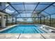 Enclosed in-ground pool with seating and distant ocean views at 705 89Th Nw Ct, Bradenton, FL 34209