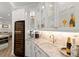 Elegant wet bar with marble countertops, custom cabinets, wine cooler, coffee maker and gold faucet and wine glass storage at 705 89Th Nw Ct, Bradenton, FL 34209