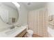 Bathroom with modern vanity, round mirror, and shower-tub combo at 7810 34Th E Ct, Sarasota, FL 34243
