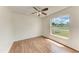 Bedroom featuring a ceiling fan, a large window, and wood-look flooring at 7810 34Th E Ct, Sarasota, FL 34243
