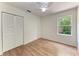 Bedroom featuring a ceiling fan, a large window, and wood-look flooring at 7810 34Th E Ct, Sarasota, FL 34243