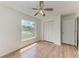 Bedroom featuring a ceiling fan, a large window, and wood-look flooring at 7810 34Th E Ct, Sarasota, FL 34243