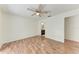 Spacious bedroom featuring stylish wood floors, ceiling fan, and a view into the ensuite bathroom at 7810 34Th E Ct, Sarasota, FL 34243