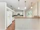 Bright kitchen features white cabinets, breakfast bar with pendant lighting, and tile backsplash at 7810 34Th E Ct, Sarasota, FL 34243
