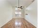 Dining room with large window, wood-look floors, and modern ceiling fan at 7810 34Th E Ct, Sarasota, FL 34243