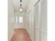 Inviting foyer with tile flooring, decorative lighting, and a closet at 7810 34Th E Ct, Sarasota, FL 34243