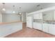 Open-concept kitchen with white appliances and stylish tile backsplash at 7810 34Th E Ct, Sarasota, FL 34243
