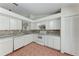 Well-lit kitchen featuring white cabinets, tiled backsplash, and modern appliances at 7810 34Th E Ct, Sarasota, FL 34243