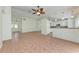 Open-concept living area with tile flooring, flowing into the kitchen and front entrance at 7810 34Th E Ct, Sarasota, FL 34243