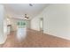 Open floor plan with tile and wood flooring and sliding glass door to the outdoors at 7810 34Th E Ct, Sarasota, FL 34243