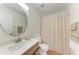 Bathroom features tile floors, a modern vanity with a round mirror, and a shower with a striped curtain at 7810 34Th E Ct, Sarasota, FL 34243