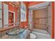 Stylish bathroom with a unique glass bowl sink and tiled shower-tub combination at 8105 Warwick Gardens Ln, University Park, FL 34201
