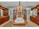 Spacious primary bathroom features dual vanities, a soaking tub with jets, and travertine floors at 8105 Warwick Gardens Ln, University Park, FL 34201