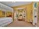 Bright bedroom features a four-poster bed, seating area with bay windows and lots of natural light at 8105 Warwick Gardens Ln, University Park, FL 34201