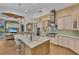 Gourmet kitchen with stainless steel appliances, island seating, and ample counter space at 8105 Warwick Gardens Ln, University Park, FL 34201