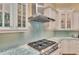 Modern kitchen features light blue backsplash, sleek stainless hood and colorful blue and white marble countertops at 8105 Warwick Gardens Ln, University Park, FL 34201