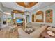 Spacious living room features wood accents, a large sectional couch, and view to an outdoor patio at 8105 Warwick Gardens Ln, University Park, FL 34201
