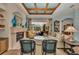 Cozy living room with fireplace and floral accents offers views of screened pool and patio at 8105 Warwick Gardens Ln, University Park, FL 34201