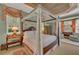 Spacious main bedroom features a decorative canopy bed, neutral walls, and large windows at 8105 Warwick Gardens Ln, University Park, FL 34201