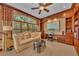 Elegant office space featuring custom built-in bookshelves, desk, and large window views at 8105 Warwick Gardens Ln, University Park, FL 34201