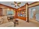 Elegant office space with custom built-in bookshelves, desk, and neutral carpeting at 8105 Warwick Gardens Ln, University Park, FL 34201