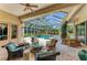 Outdoor patio seating area overlooking screened-in pool and lush landscaping at 8105 Warwick Gardens Ln, University Park, FL 34201