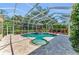 An inviting screened-in pool with decorative umbrella and beautiful landscaping at 8105 Warwick Gardens Ln, University Park, FL 34201