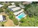 An elevated view showcasing a private backyard pool and patio, surrounded by lush greenery and neighborhood homes at 8408 Whispering Woods Ct, Lakewood Ranch, FL 34202