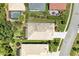 Birds-eye view of the house with a screened patio and lush greenery at 8408 Whispering Woods Ct, Lakewood Ranch, FL 34202