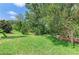 Well-maintained backyard features a lush green lawn and mature trees, providing a tranquil and inviting outdoor space at 8408 Whispering Woods Ct, Lakewood Ranch, FL 34202
