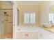 Well-lit bathroom with shower, soaking tub, and vessel sink at 8408 Whispering Woods Ct, Lakewood Ranch, FL 34202