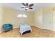 Cozy bedroom with hardwood floors, a ceiling fan, and an arched window at 8408 Whispering Woods Ct, Lakewood Ranch, FL 34202