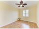 Bedroom with wood floors, a ceiling fan and a window with shutters at 8408 Whispering Woods Ct, Lakewood Ranch, FL 34202