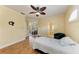 Spacious bedroom with hardwood floors, a ceiling fan, and an en-suite bathroom at 8408 Whispering Woods Ct, Lakewood Ranch, FL 34202
