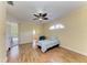 Bedroom with beautiful hardwood floors, ceiling fan, and private access to the backyard patio at 8408 Whispering Woods Ct, Lakewood Ranch, FL 34202