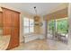 Cozy breakfast nook with built-in seating, a pendant light, and access to the screened patio at 8408 Whispering Woods Ct, Lakewood Ranch, FL 34202